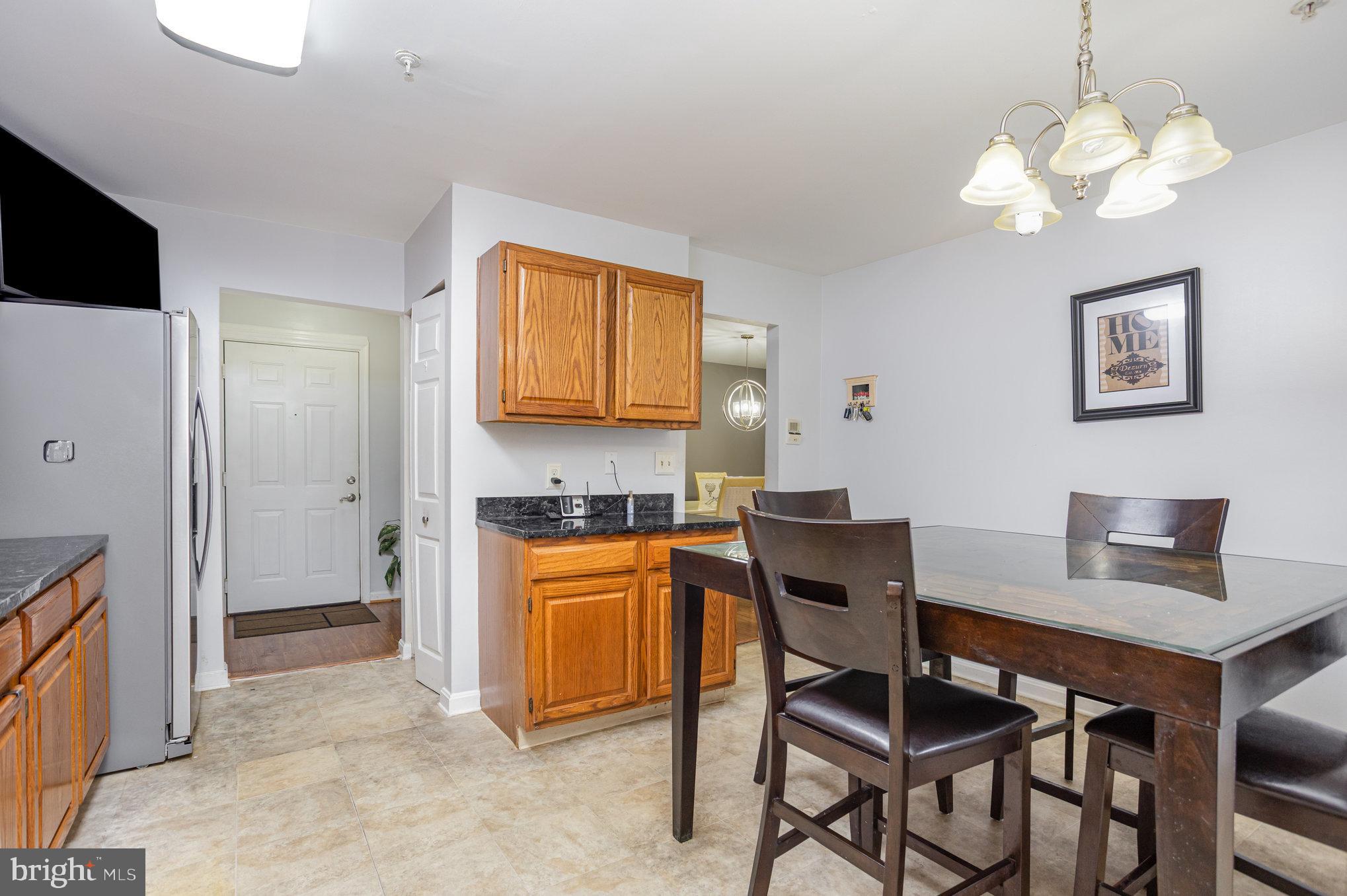3905 Darleigh Road, Unit F Nottingham, MD 21236 - Photo 13 of 33 a view of a dining room with furniture and a chandelier