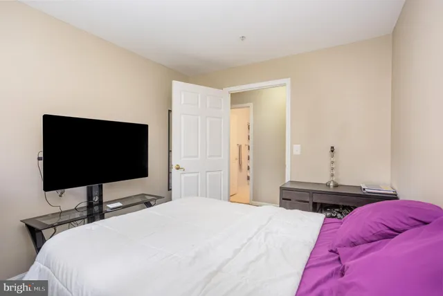 a bedroom with a bed and a flat screen tv