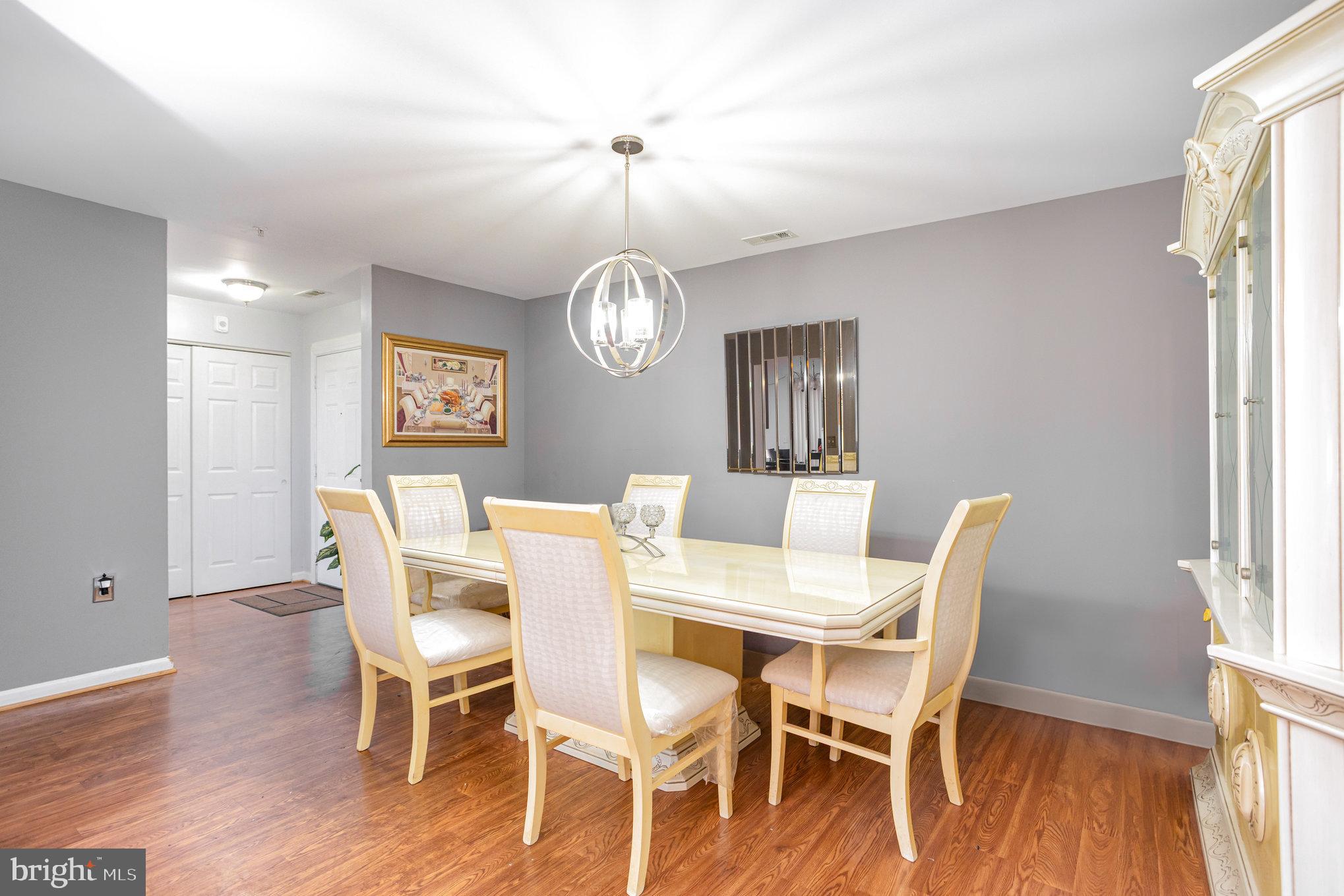 3905 Darleigh Road, Unit F Nottingham, MD 21236 - Photo 5 of 33 a view of a dining room with furniture a chandelier and wooden floor