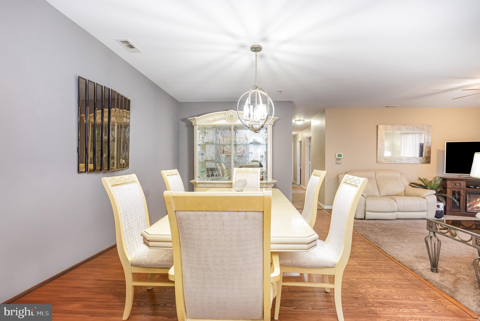 3905 Darleigh Road, Unit F Nottingham, MD 21236 - Photo 6 of 33 a view of a dining room with furniture a chandelier and wooden floor
