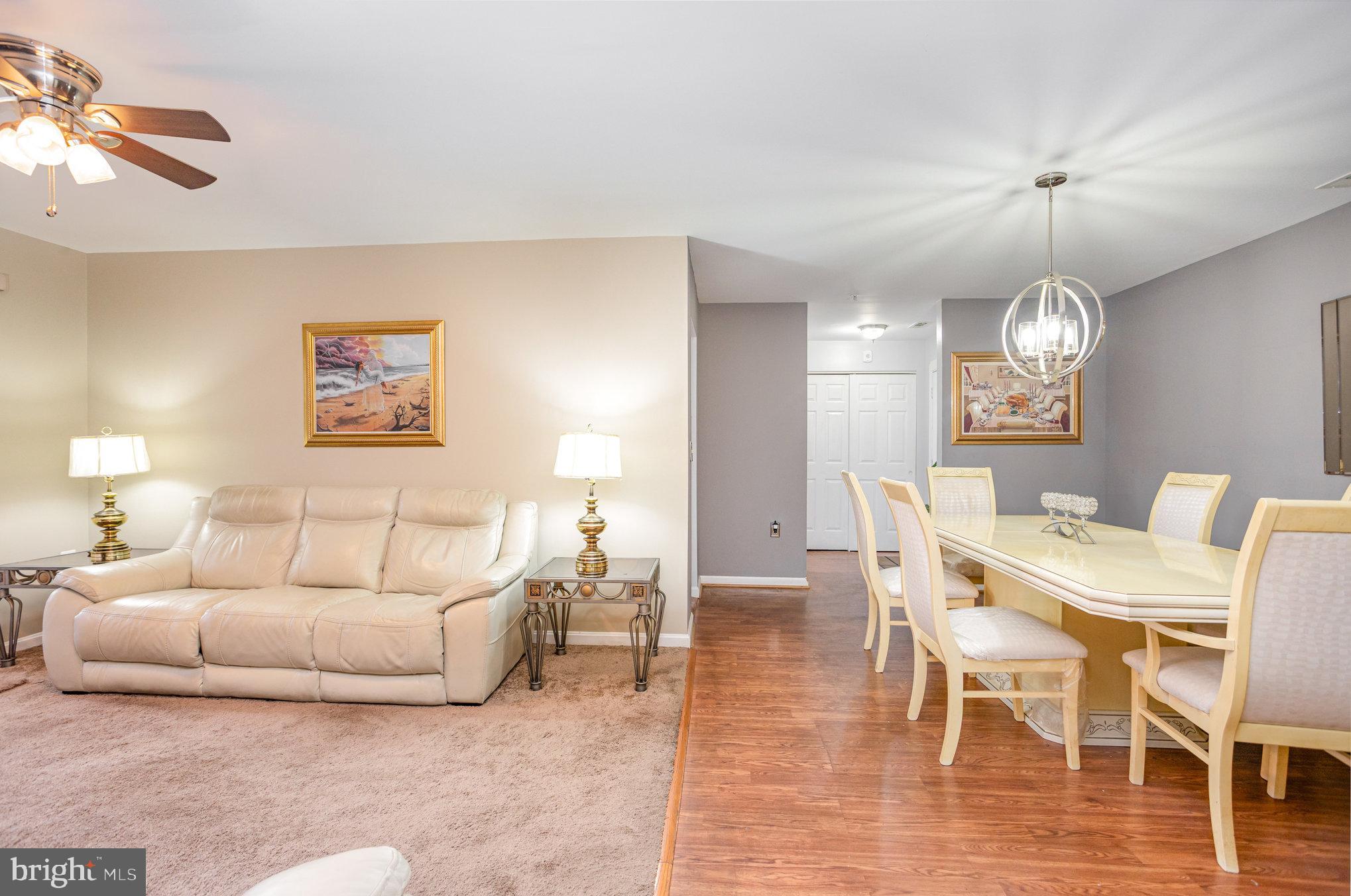 3905 Darleigh Road, Unit F Nottingham, MD 21236 - Photo 7 of 33 a living room with furniture a dining table and a chandelier
