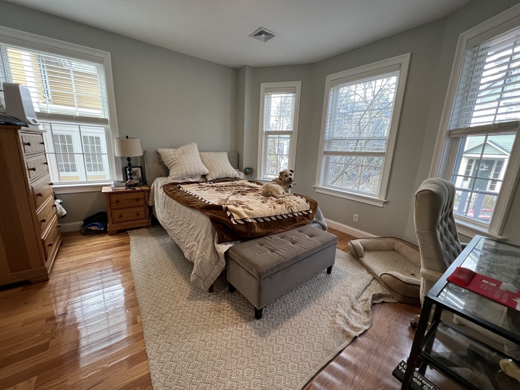20 Kenton Road, Unit 2 Boston, MA 02130 - Photo 9 of 20 a spacious bedroom with a bed and wooden floor