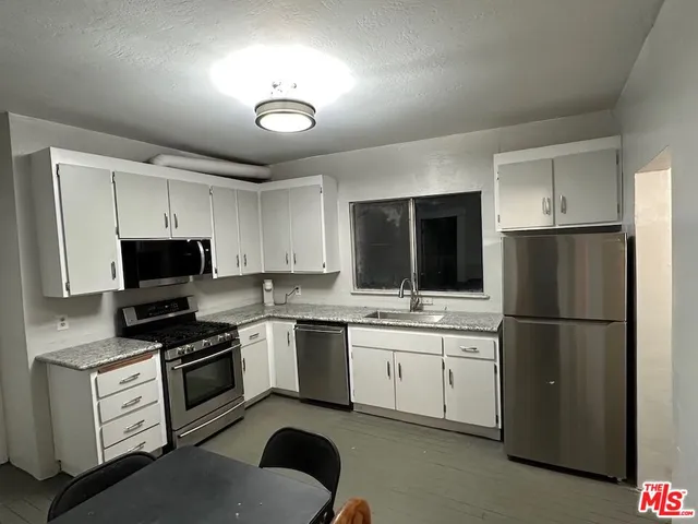 a kitchen with a refrigerator stove and microwave