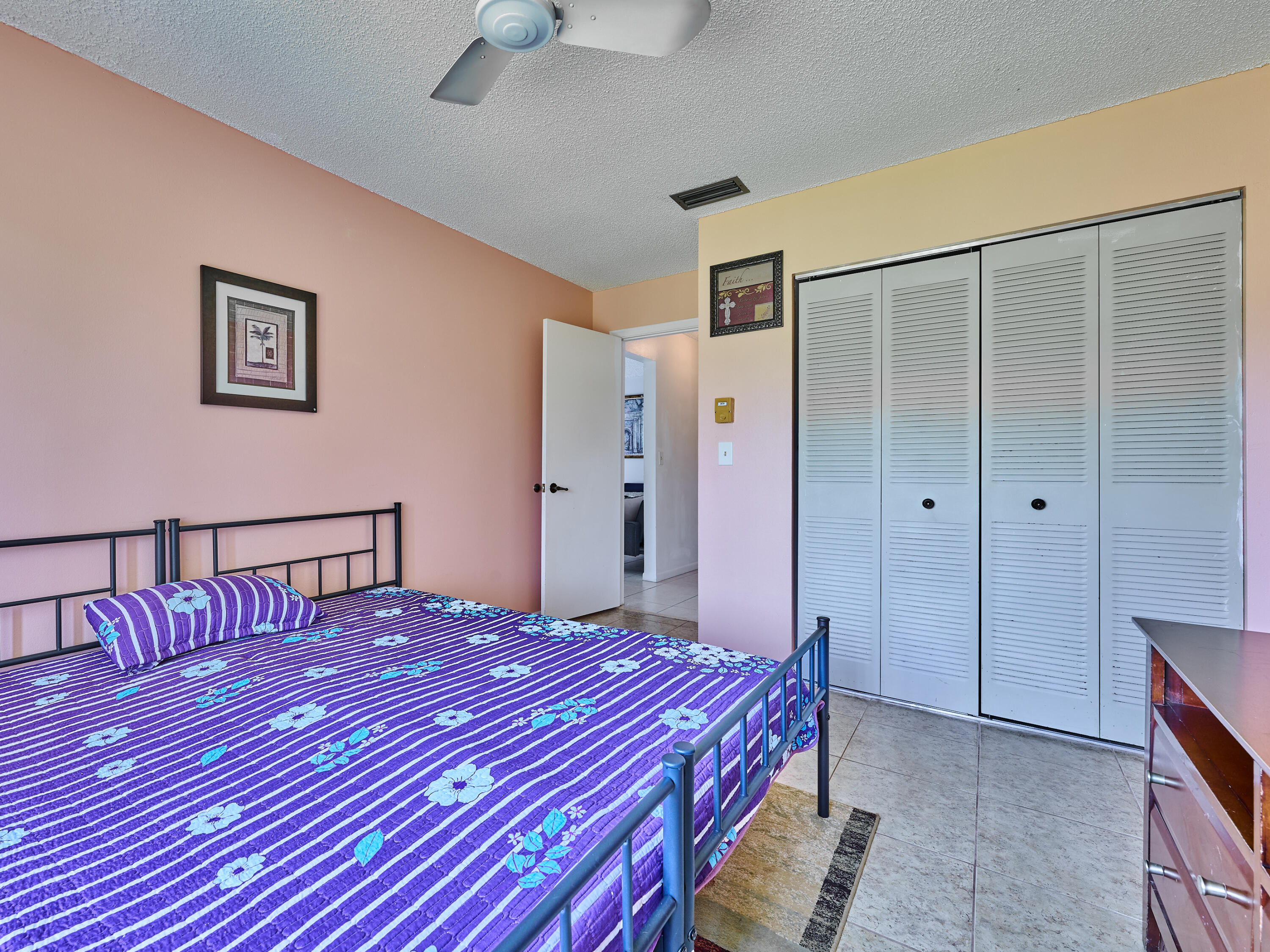 5197 Minto Road Boynton Beach, FL 33472 - Photo 19 of 32 a bedroom with a large bed and a chandelier