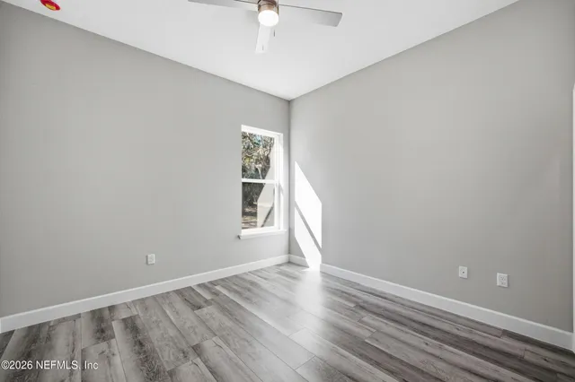 wooden floor in an empty room with a window