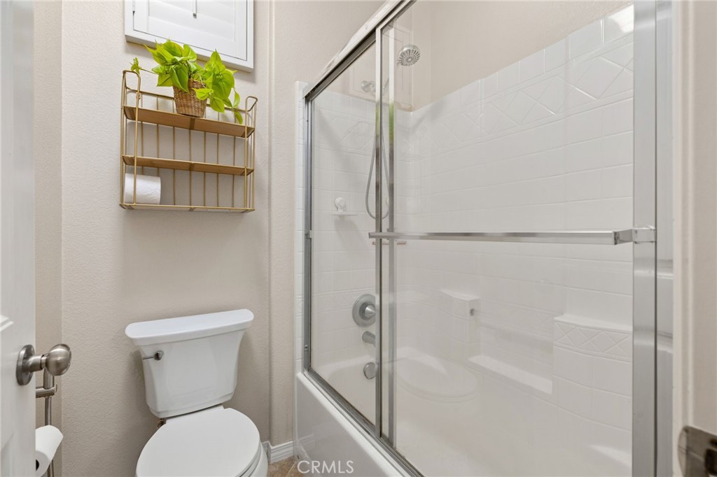 30355 Lamplighter Lane Menifee, CA 92584 - Photo 14 of 31 a bathroom with a toilet and a shower
