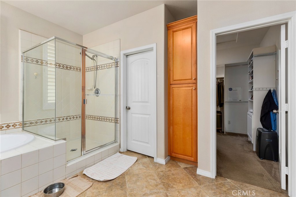 30355 Lamplighter Lane Menifee, CA 92584 - Photo 16 of 31 a bathroom with a tub and shower