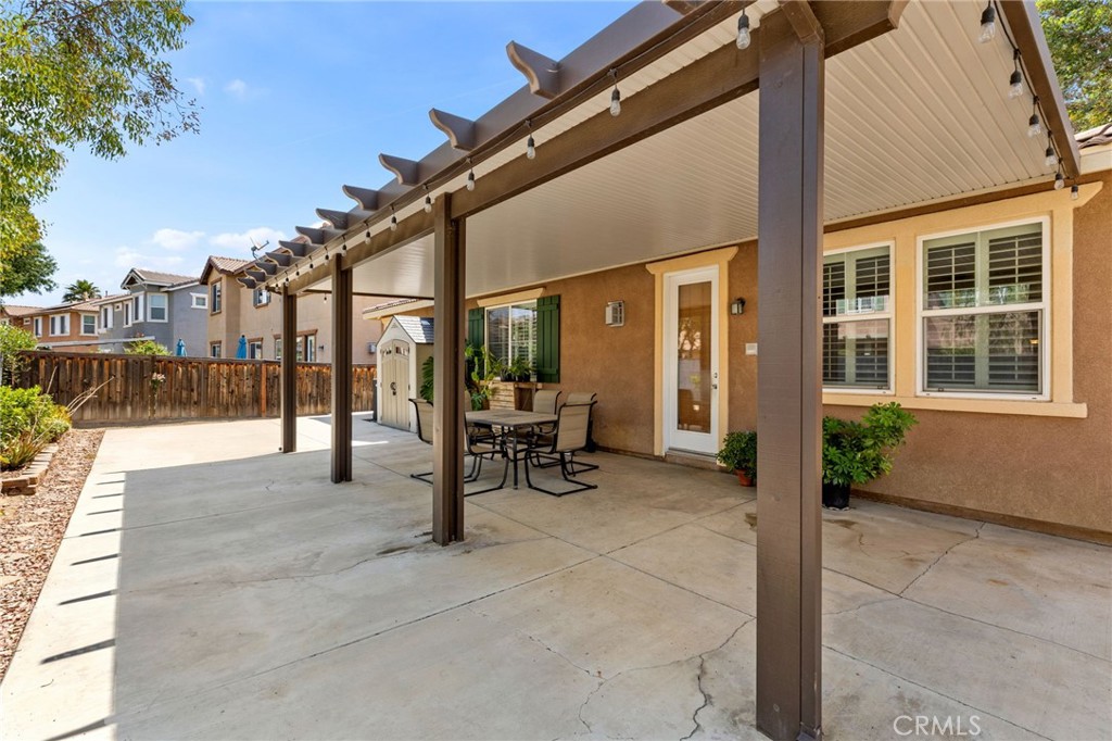30355 Lamplighter Lane Menifee, CA 92584 - Photo 21 of 31 a view of a building with couch and wooden fence