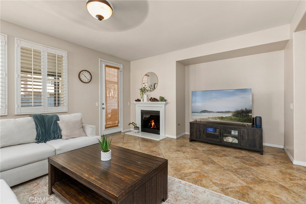 30355 Lamplighter Lane Menifee, CA 92584 - Photo 4 of 31 a living room with furniture and a fireplace