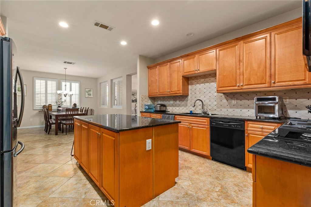 30355 Lamplighter Lane Menifee, CA 92584 - Photo 7 of 31 a kitchen with stainless steel appliances granite countertop sink stove top oven and cabinets