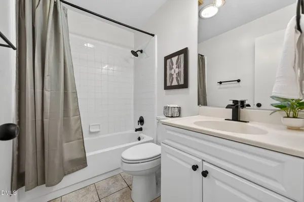 a bathroom with a sink a toilet a mirror and shower