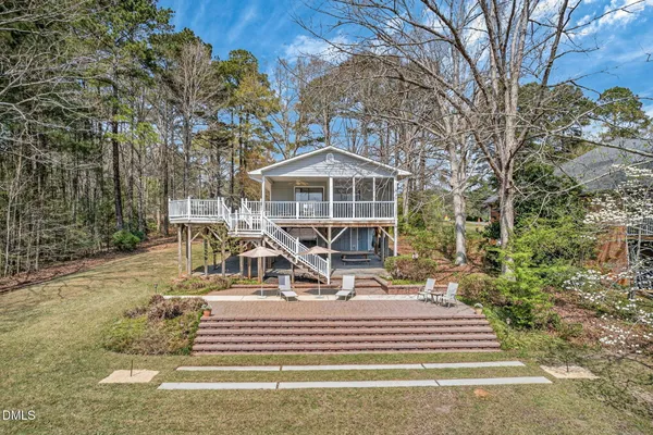 a view of a house with backyard porch and sitting area