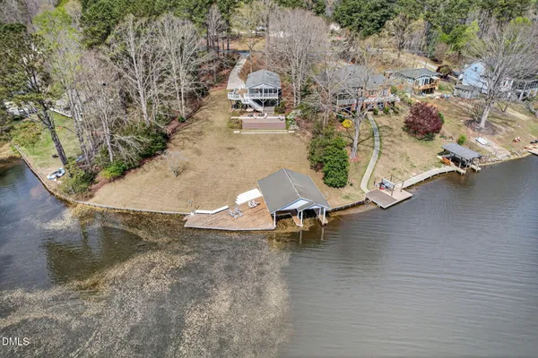an aerial view of a swimming pool with lounge chair