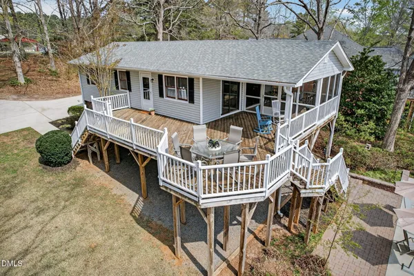 a roof deck with table and chairs