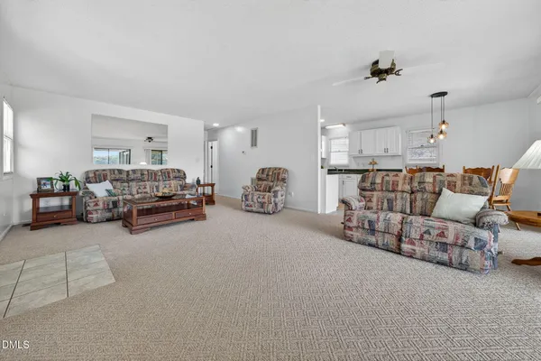 a living room with furniture and a lamp