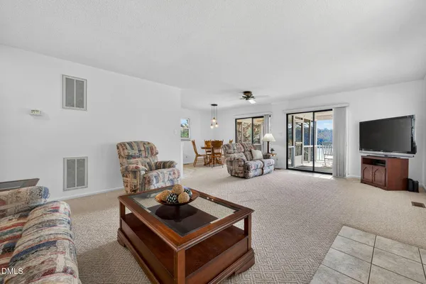 a living room with furniture a flat screen tv and a couch