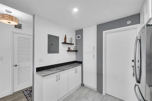 a spacious bathroom with a granite countertop sink and a mirror