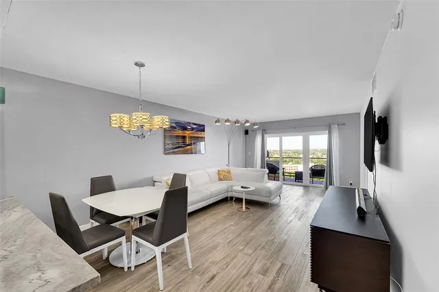 a living room with furniture flat screen tv and wooden floor