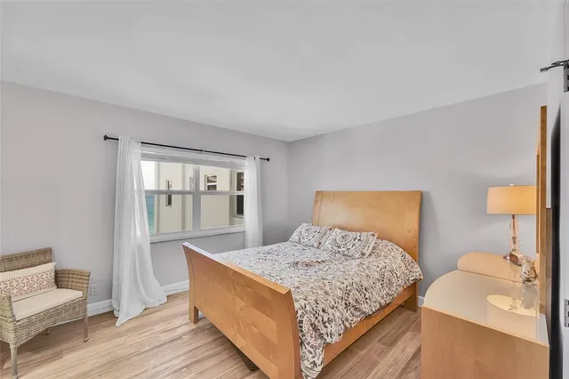 a bedroom with a large bed and a window