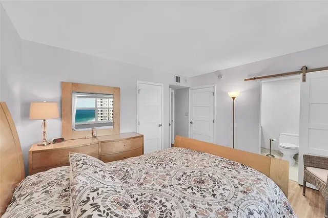 a bedroom with a bed and a dresser in it