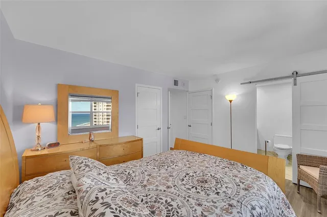 a bedroom with a bed and a dresser in it