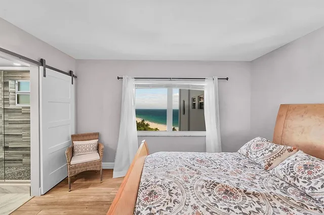 a bedroom with a bed and a window with outer view