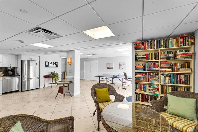 a living room with furniture a piano and a bookshelf
