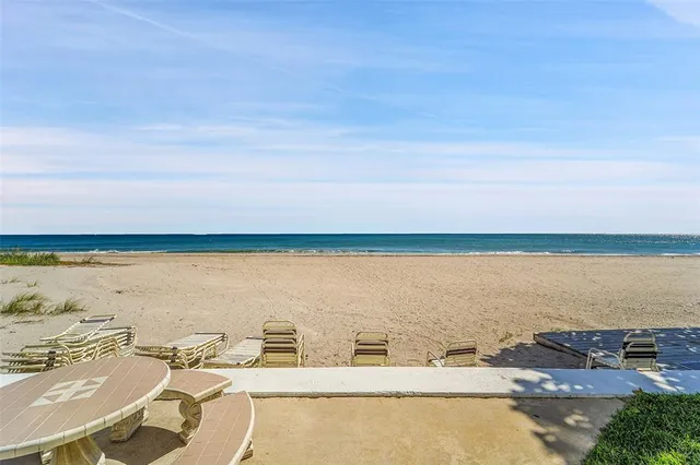 a kitchen with stainless steel appliances kitchen island granite countertop a refrigerator and a stove top oven