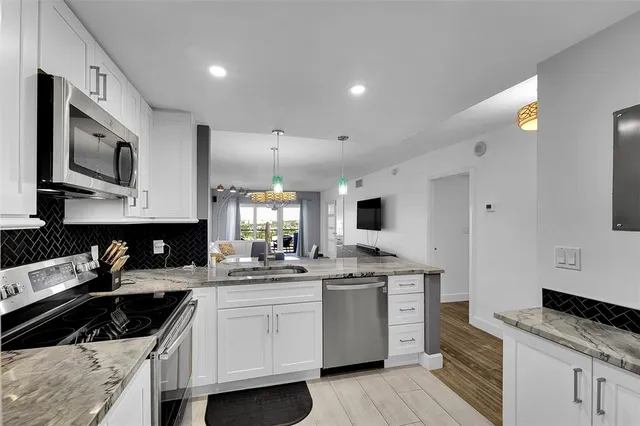 a kitchen with a sink stove and cabinets