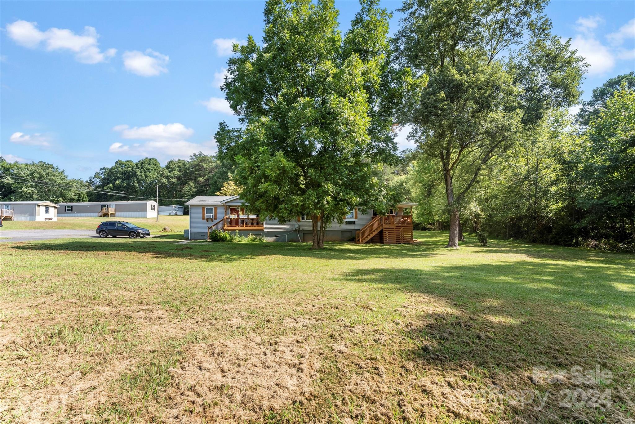 1148 Wagon Wheel Road Hickory, NC 28602 - Photo 15 of 35 a small garden covered with tall trees