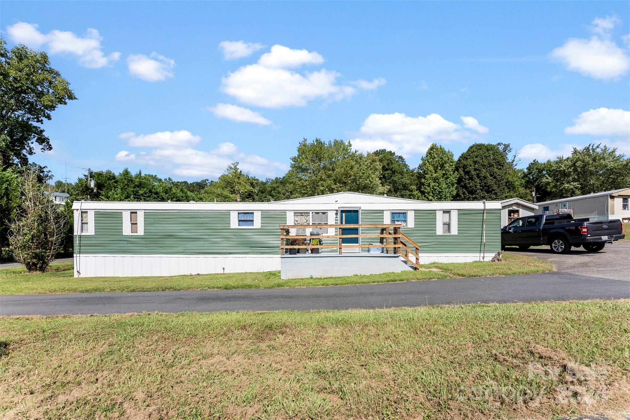 1148 Wagon Wheel Road Hickory, NC 28602 - Photo 17 of 35 a front view of a house with a garden and lake view