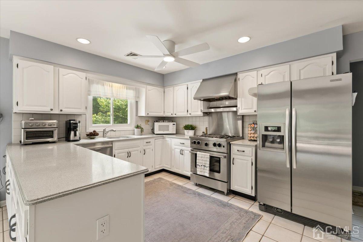 18 Lance Road Lebanon, NJ 08833 - Photo 13 of 45 a kitchen with a refrigerator sink and cabinets