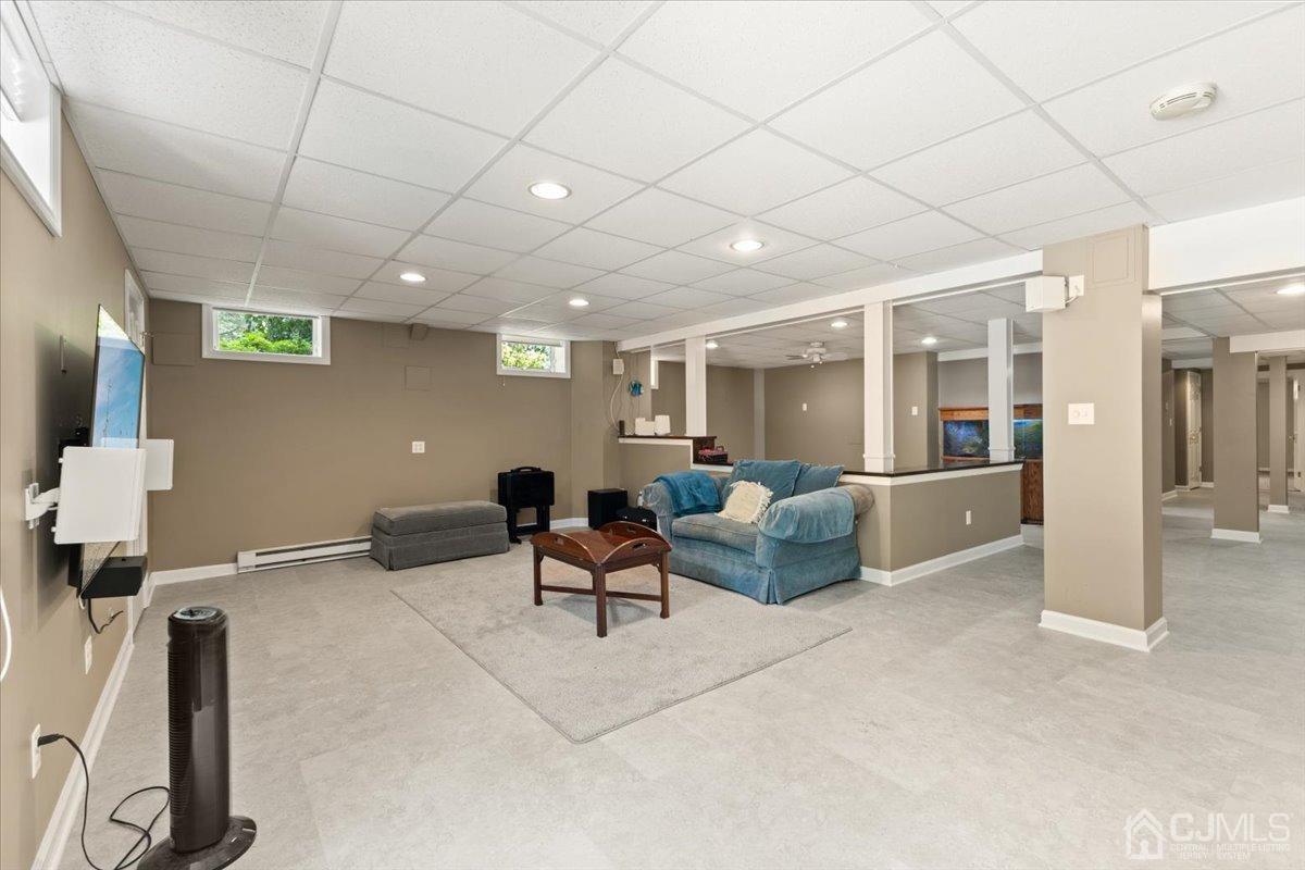 18 Lance Road Lebanon, NJ 08833 - Photo 29 of 45 a living room with furniture a table and a flat screen tv