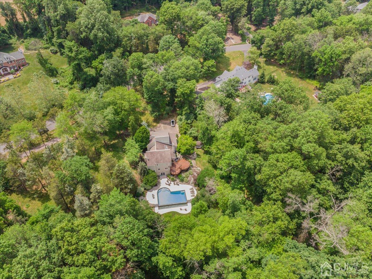 18 Lance Road Lebanon, NJ 08833 - Photo 37 of 45 a backyard of a house with outdoor seating and covered with trees
