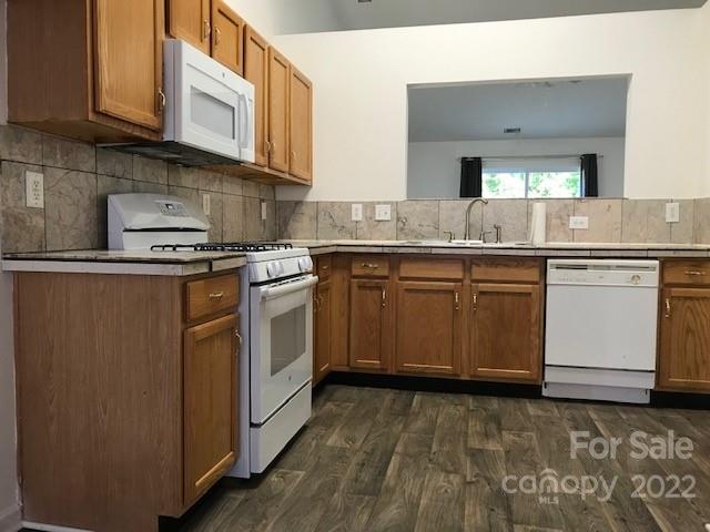 8232 Fox Swamp Road Charlotte, NC 28215 - Photo 14 of 19 a kitchen with a stove sink and cabinets