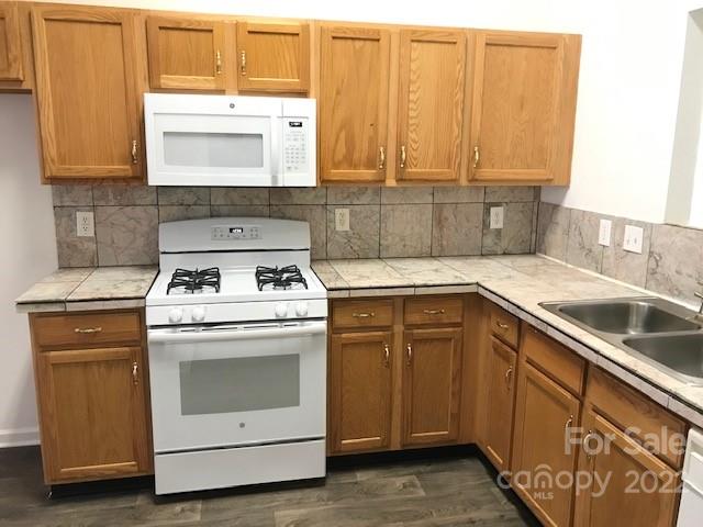 8232 Fox Swamp Road Charlotte, NC 28215 - Photo 15 of 19 a kitchen with a sink stove and cabinets