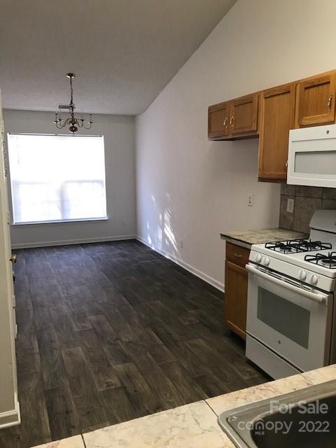 8232 Fox Swamp Road Charlotte, NC 28215 - Photo 16 of 19 a kitchen with a stove and a wooden floors