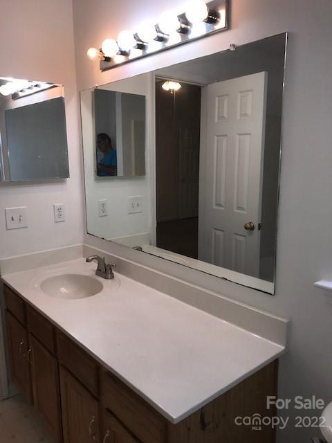 8232 Fox Swamp Road Charlotte, NC 28215 - Photo 17 of 19 a bathroom with a sink vanity and mirror