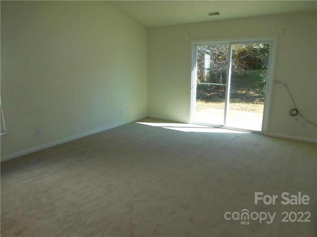 8232 Fox Swamp Road Charlotte, NC 28215 - Photo 4 of 19 a view of an empty room with a window