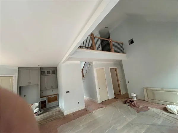 a view of a livingroom with wooden floor and a ceiling fan