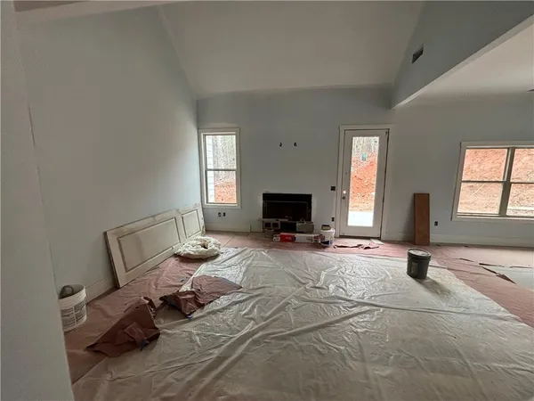 a living room with furniture a flat screen tv and a window