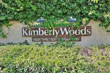 a sign broad in front of flowers