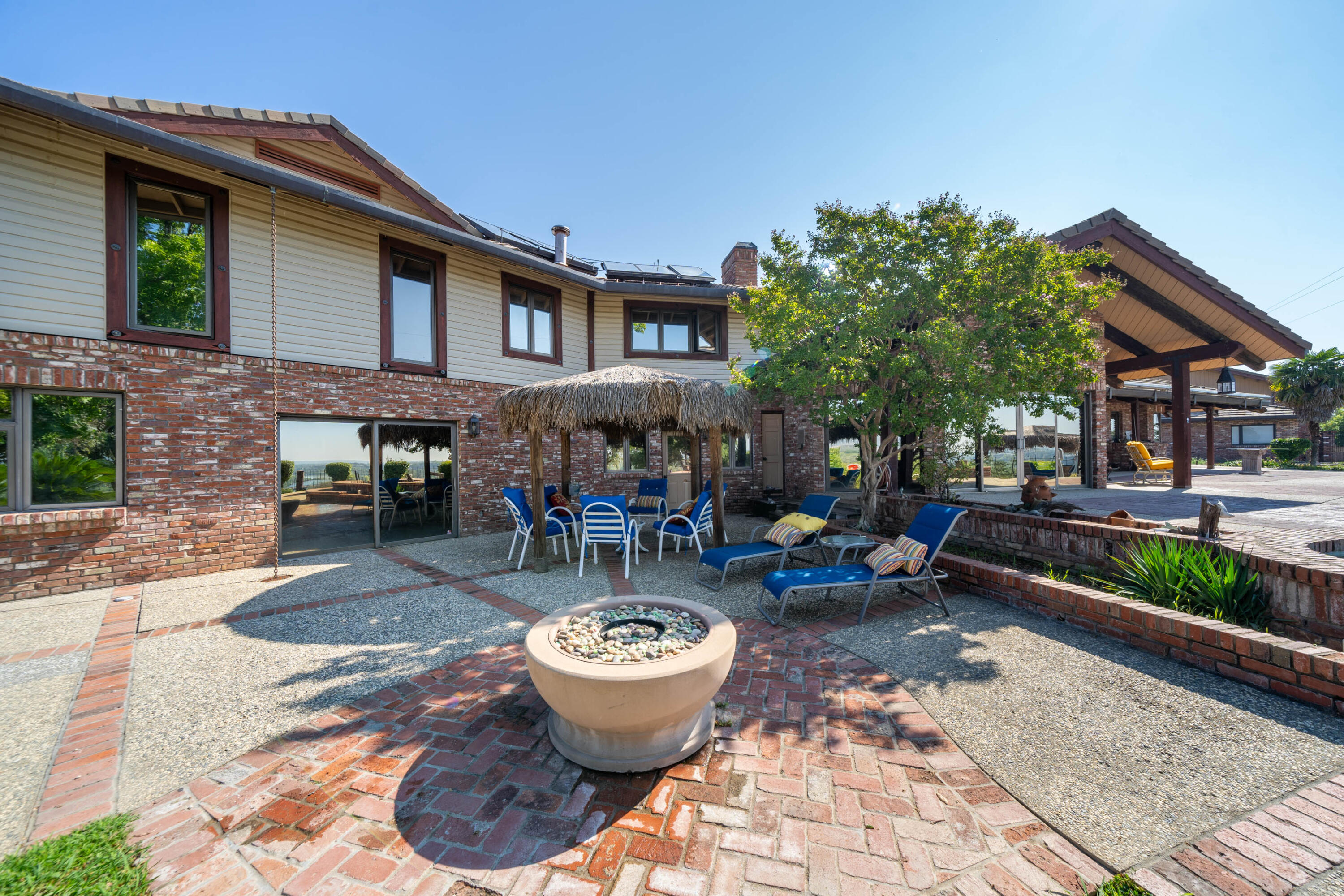 910 River Bend Road Redding, CA 96003 - Photo 18 of 92 a view of a patio with dining table and chairs and potted plants