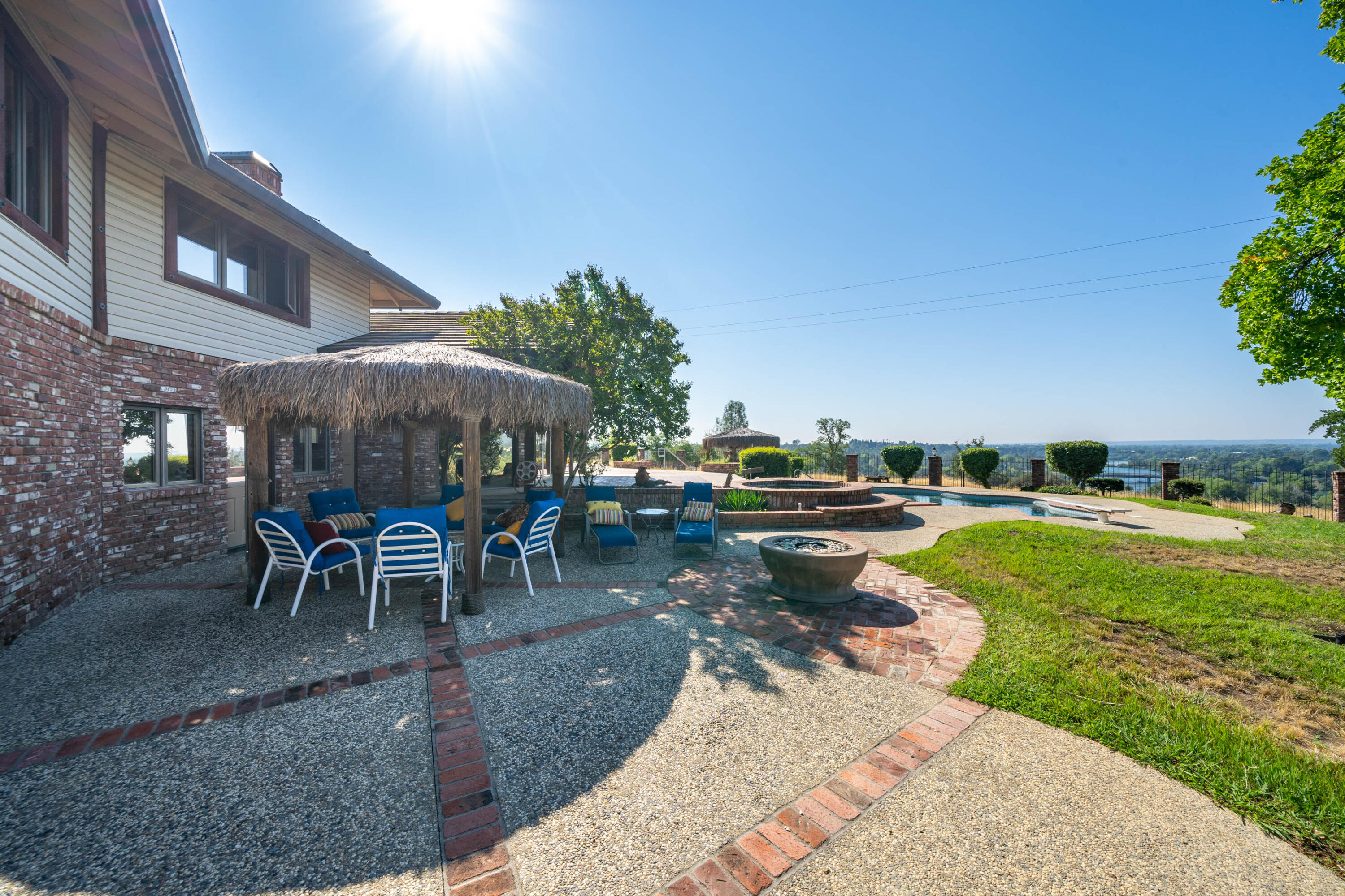 910 River Bend Road Redding, CA 96003 - Photo 19 of 92 a view of a patio with a table and chairs under an umbrella