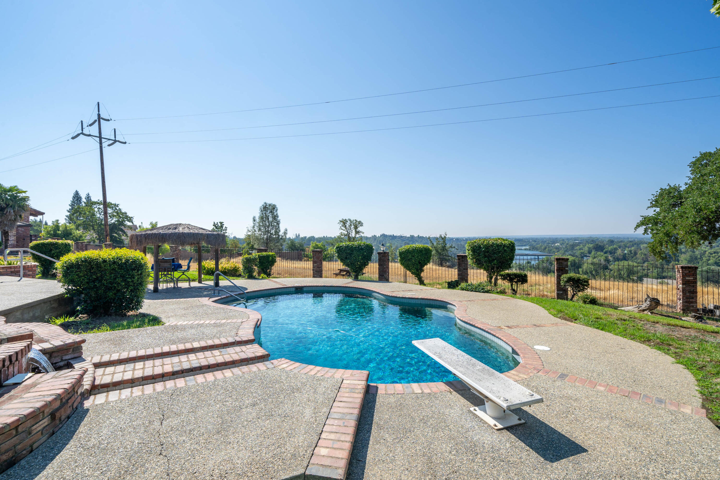 910 River Bend Road Redding, CA 96003 - Photo 27 of 92 a view of a swimming pool with lawn chairs and a yard