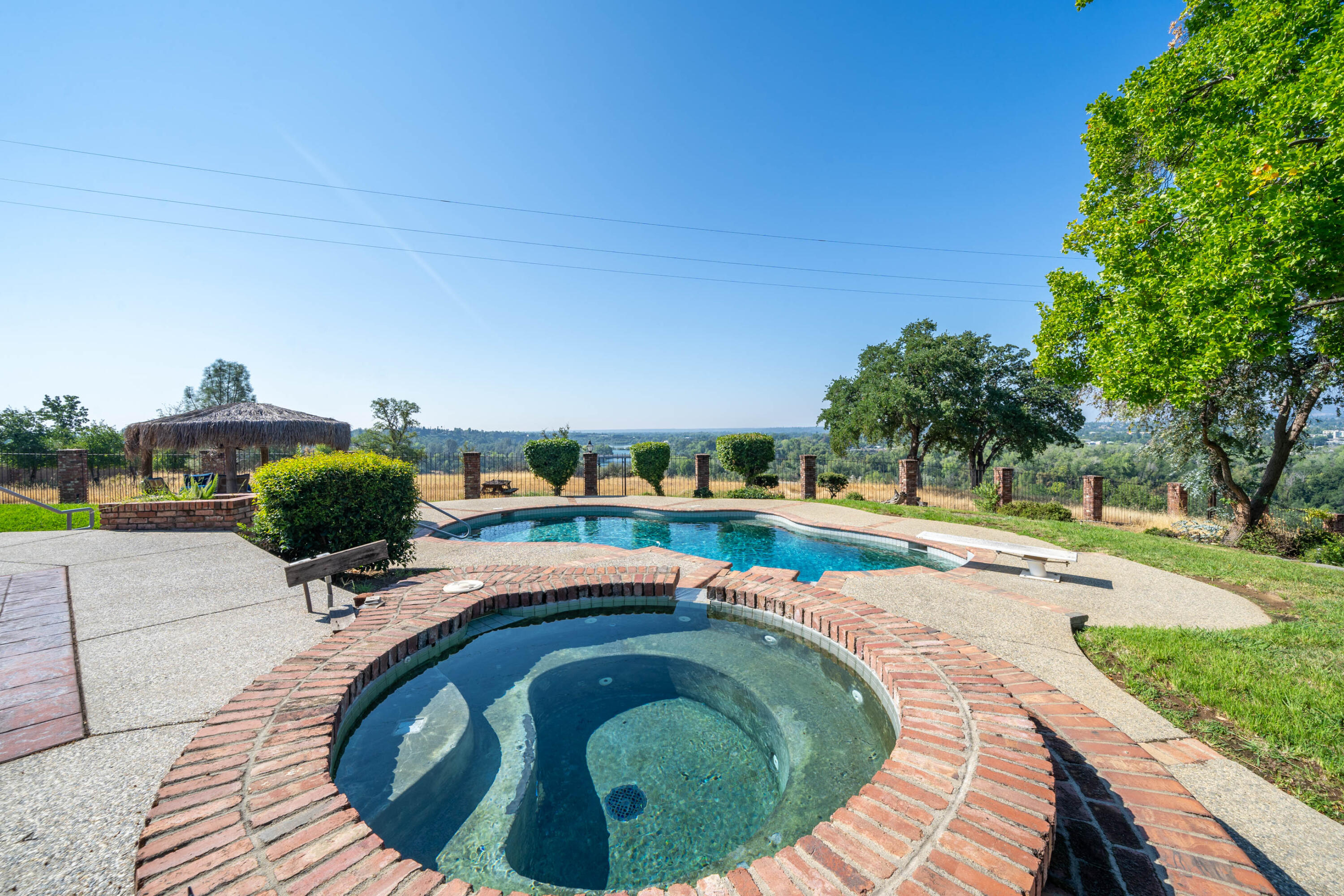 910 River Bend Road Redding, CA 96003 - Photo 28 of 92 a swimming pool with outdoor seating and garden