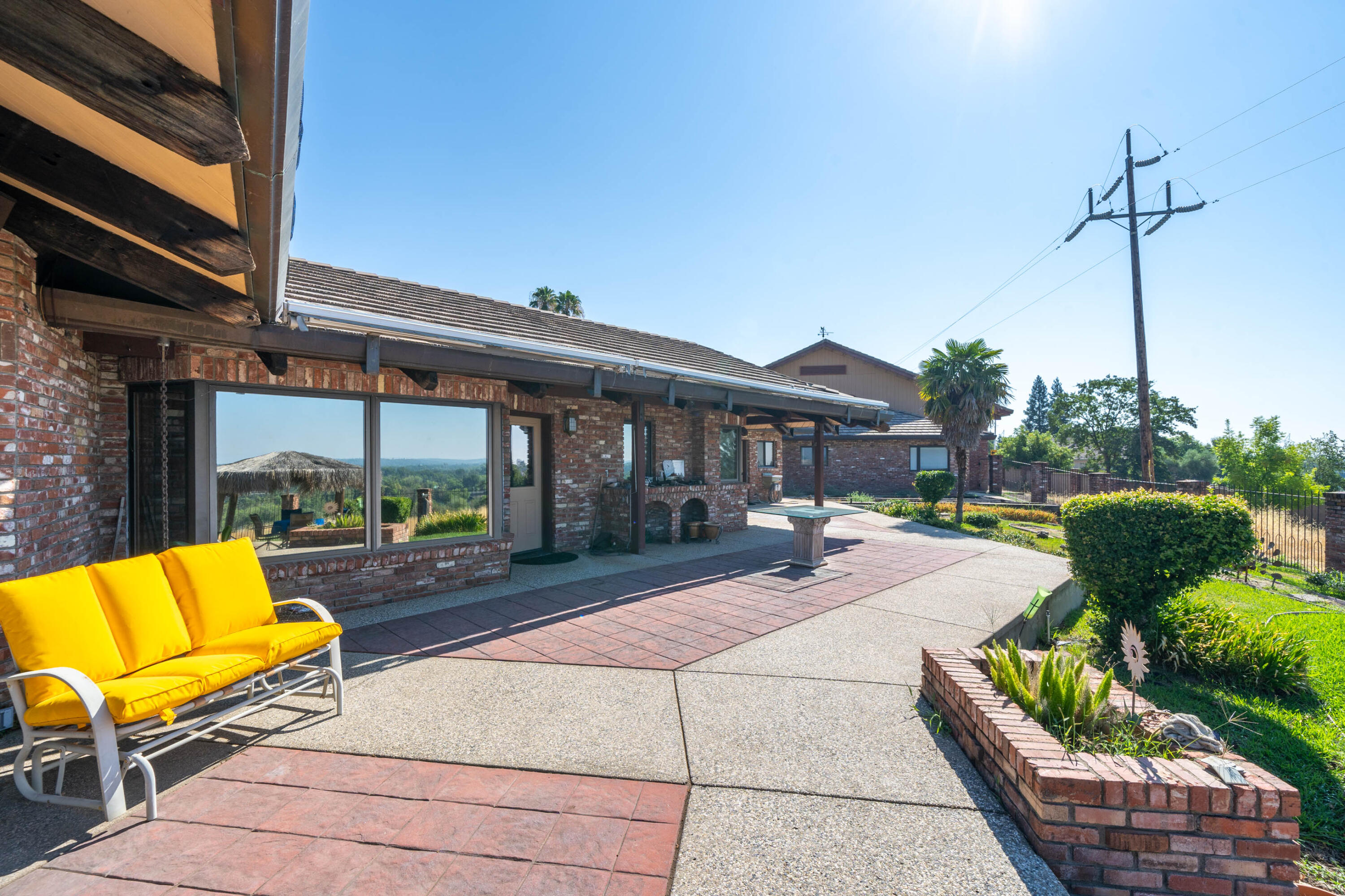 910 River Bend Road Redding, CA 96003 - Photo 33 of 92 a view of a patio with couches chairs and potted plants