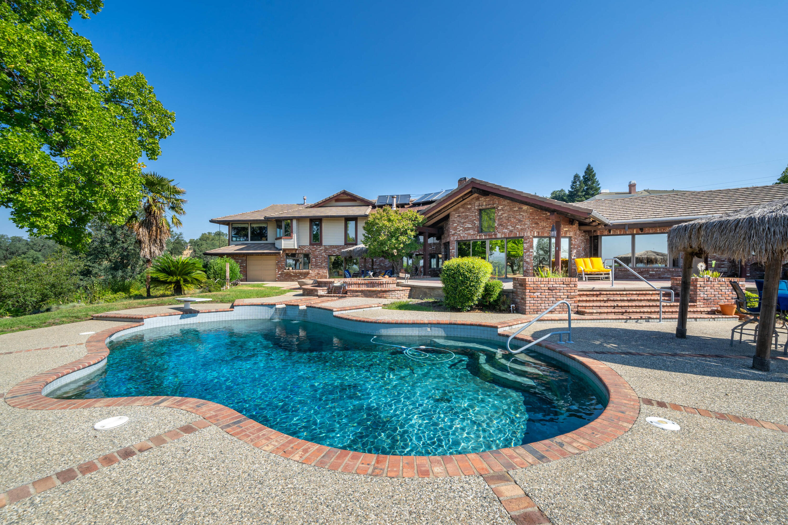 910 River Bend Road Redding, CA 96003 - Photo 4 of 92 a view of a house with swimming pool and sitting area