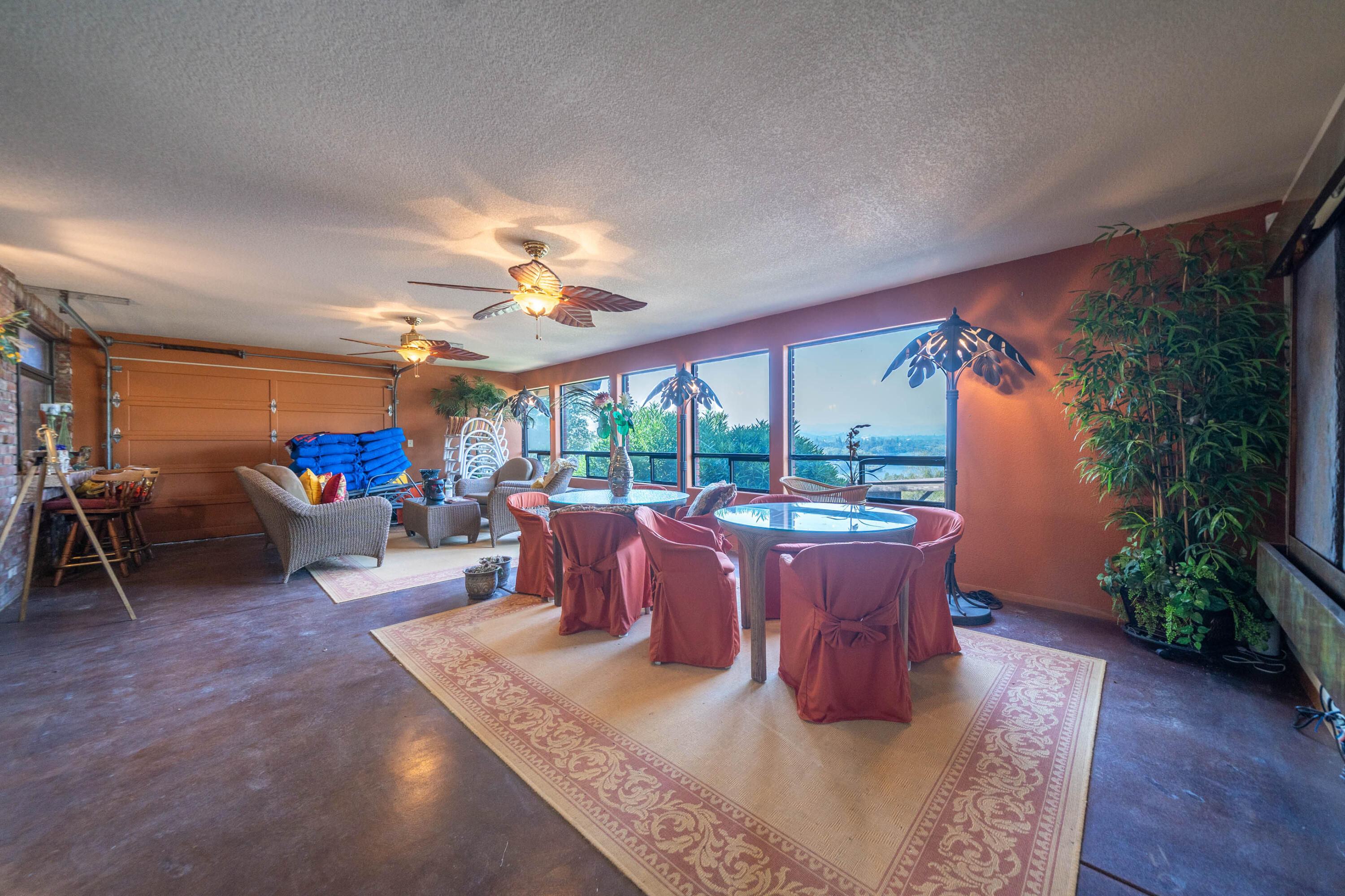 910 River Bend Road Redding, CA 96003 - Photo 59 of 92 a living room with furniture a large window and a fireplace