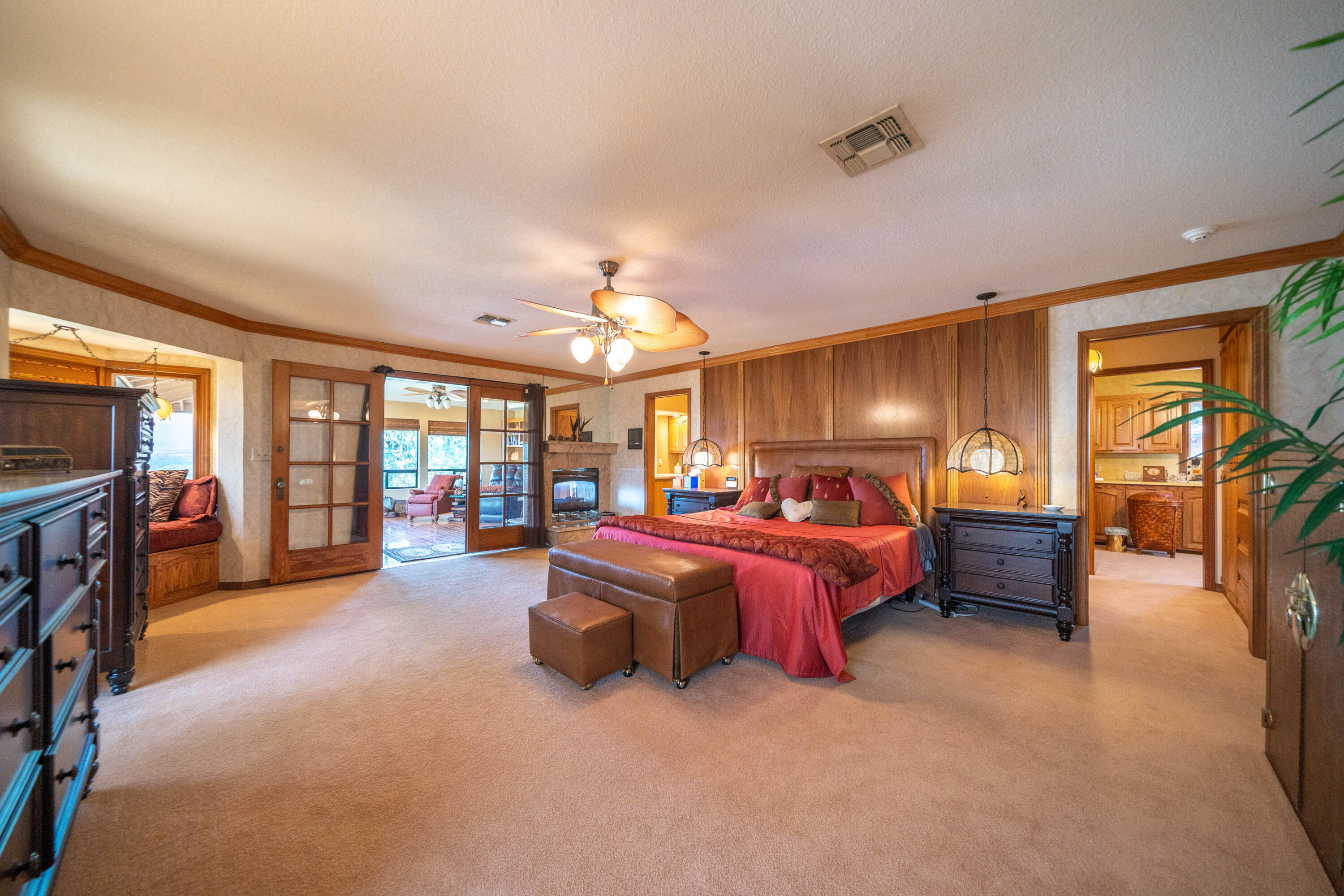 910 River Bend Road Redding, CA 96003 - Photo 69 of 92 a spacious bedroom with a bed and a chandelier